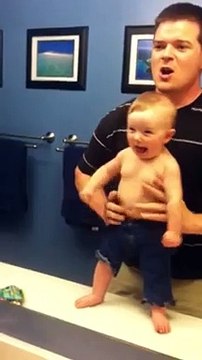Baby adorably flexes muscles with dad (480p)