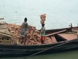 Hard labour, guy stacking 20 bricks on his head