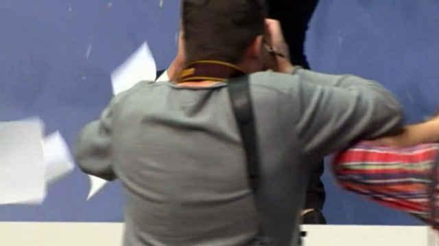 Protester showers ECB President Draghi with confetti