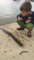 Little kid gets knocked by fish