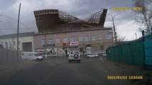 The wind tears the roof of a building In Russia