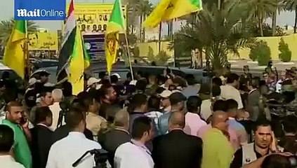 'King of Clubs' body paraded through Baghdad in glass coffin