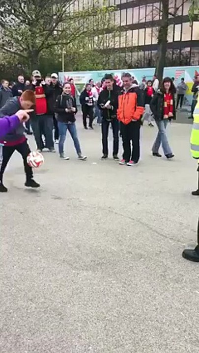 A female police officer does some keepie-uppies with young Aston Villa fans on Wembley Way!