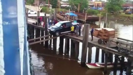 Attempting To Load A Car On A Ship Using Planks
