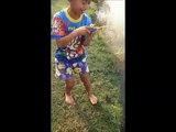 Boy catches fish with a toy fishing pole