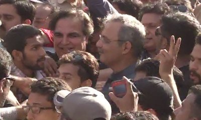 MQM's Haider Abbas and PTI candidate Imran Ismail together after polling