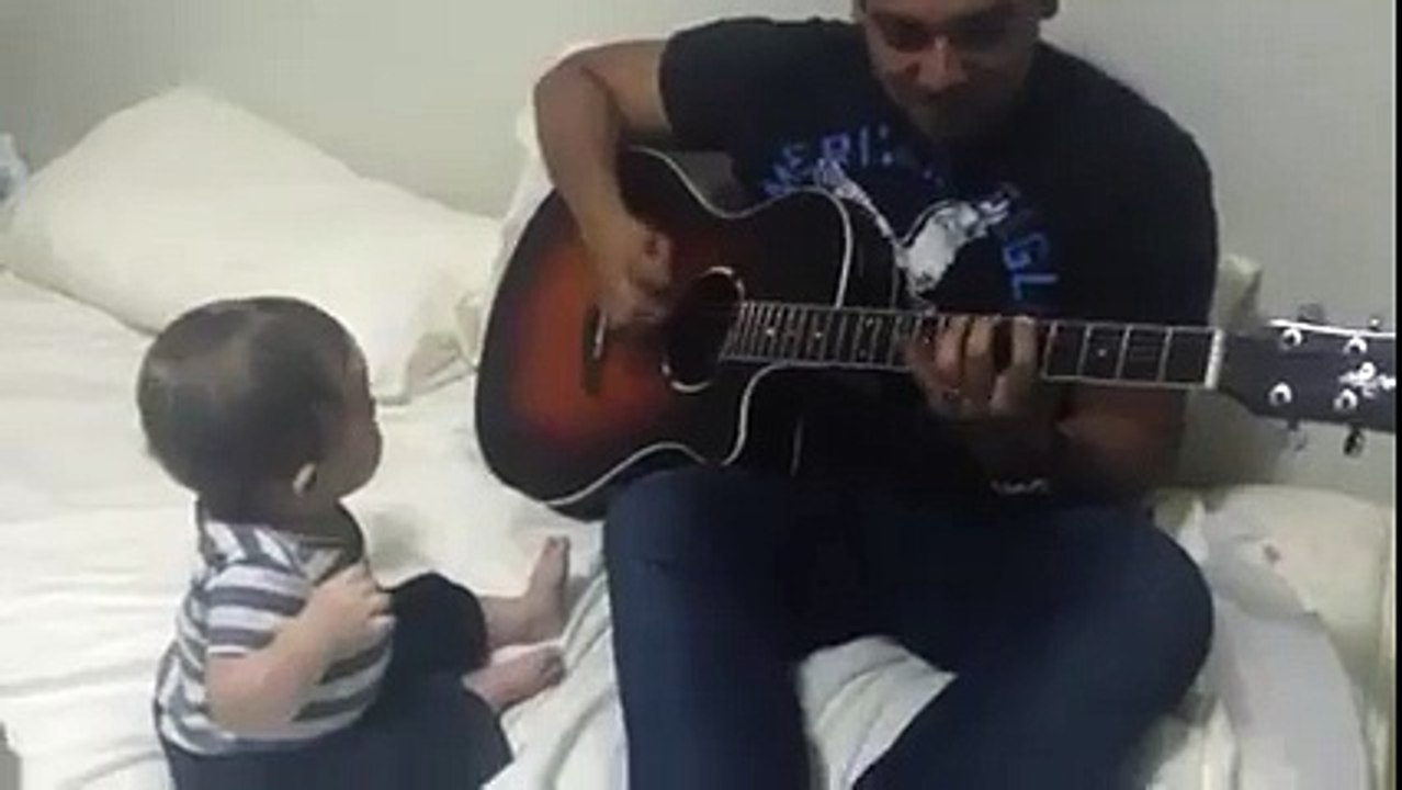 Baby laughs hysterically at guitar performance