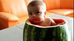 Adorable baby eats watermelon from the inside out