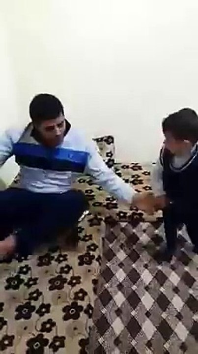 little kid trying to offer prayer with his father