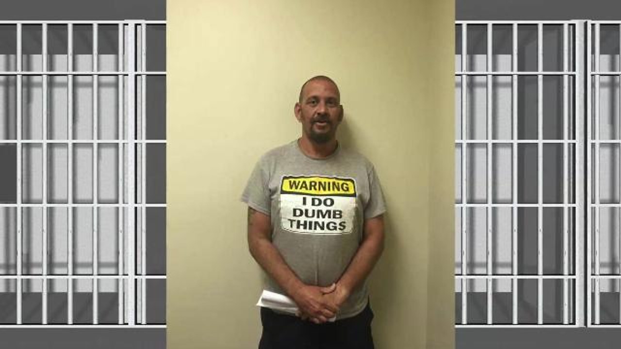 Man arrested wearing shirt reading "Warning: I...