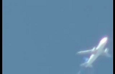 Fast UFO filmed flying past airplane.