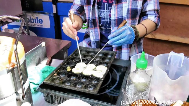 London Street Food. Japanese Octopus Snack Takoyaki. Cooked in Chinatown