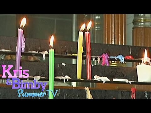 What virtues do colored candles symbolize?