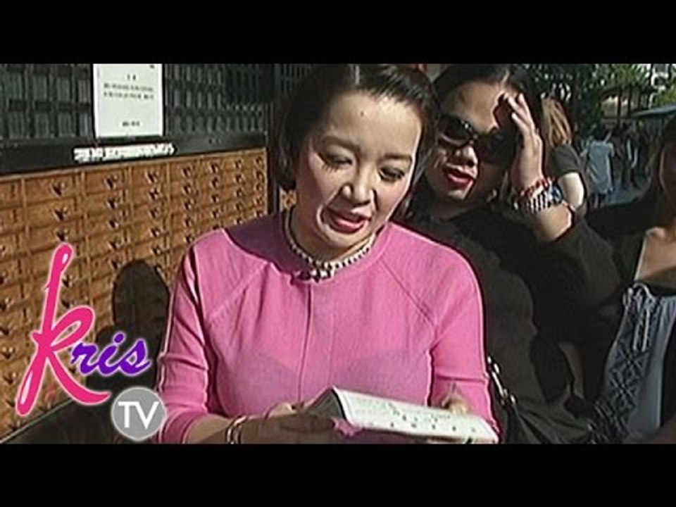 Kris reads her fortune at the Japanese temple