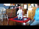 Adorable baby loves jumping on trampoline