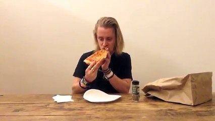 Macaulay Culkin Eating a Slice of Pizza