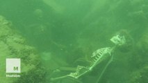Scuba diver stumbles on underwater armchair skeletons