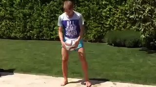 Real Madrid teenager Martin Odegaard shows off his juggling skills by a swimming pool