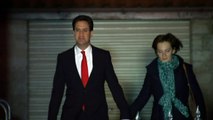 Solemn looking Ed Miliband leaves house with wife