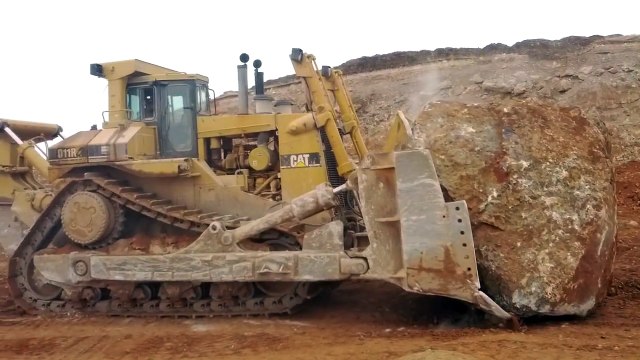 Caterpillar D11R pushing another massive rock