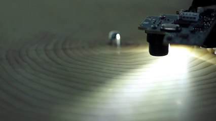 A turntable read a slice of a tree barter transcribing the music.