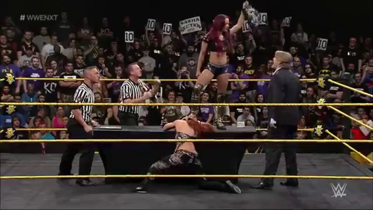 Sasha Banks and Becky Lynch sign the contract for their match at TakeOver WWE NXT, May11, 2015