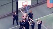 Shirtless man stuck in basketball hoop to protest Freddie Gray death in police custody - TomoNews