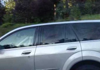 Woman Curls Her Hair While Driving Her Car
