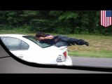 Terrifying ride: Man hangs from back of car on busy Interstate 77