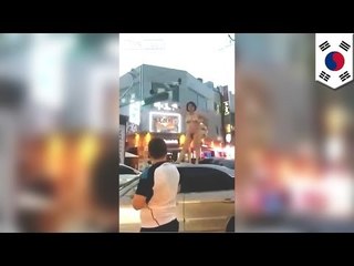 Crazy naked Korean woman on rampage strips, jumps on car in Changwon, Kyongsang-namdo