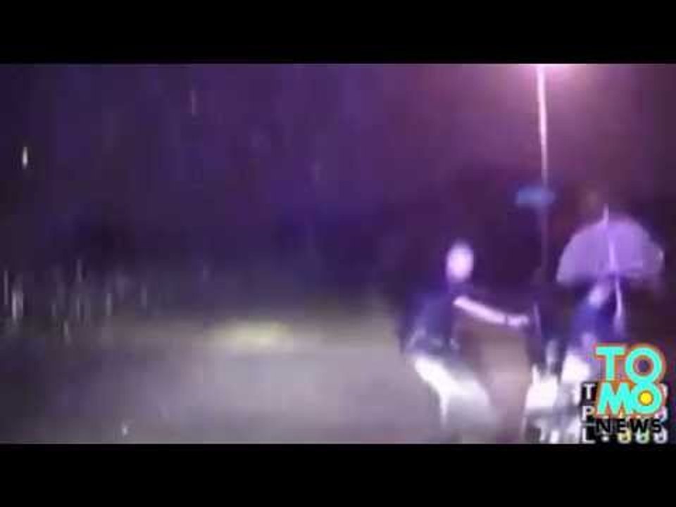 Policjant ratuje mężczyznę na wózku podczas ogromnej ulewy.