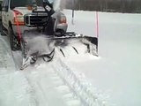Truck mounted snow blower clearing the end of the driveway