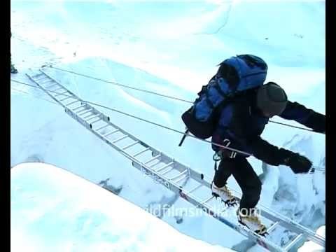 Crossing a treacherous crevasse en route Everest summit