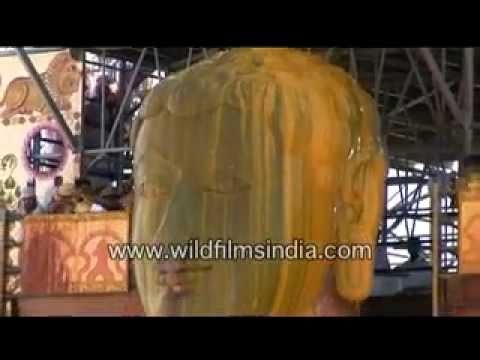 Haldi or turmeric poured over Bahubali at Shravanabelagola