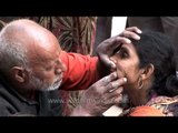 Roadside dentist works his magic on poor local woman