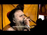 Naga Sadhu smoking a chillum