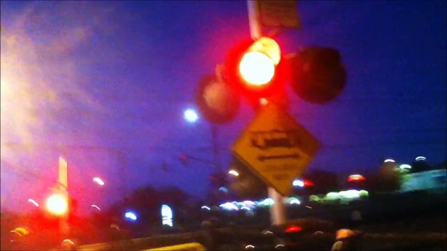 Pedestrian railroad crossing signals with union pacific freight train and light rail train