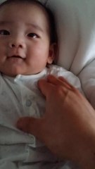 Adorable 6-week-old infant smiles for camera