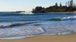 Surfer catching morning breaking waves on beach