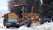 Motor Grader snow plowing and maneuvering around vehicles: Volvo G960