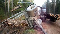 Full trailer of wood turned over, Belarus Mtz 892.2 forestry tractor  helps to get up