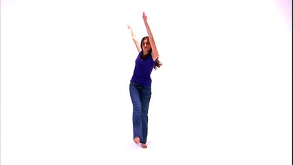 Shot of a girl in a purple shirt and jeans dancing on a white background.