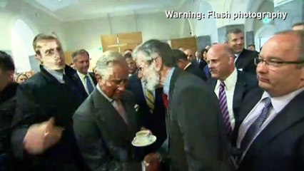 Prince Charles shakes hands with Gerry Adams