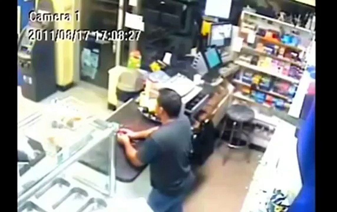 Unedited: Masked gunman confronts Machete wielding store owner (shots fired)