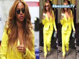 Beyonce knowles bares her cleavage in neon pantsuit
