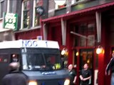 ME ontruimt cafe in Amsterdam en knalt  met bus tegen luifel