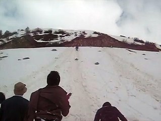 sliding on snow with friends have fun.