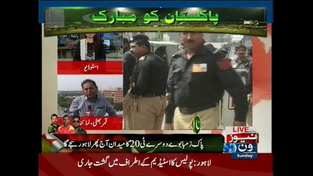 Cricket lovers stand in a queue to enter the Gaddafi stadium in Lahore