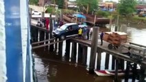 SUV Car attempting to load on a ship over some planks : so talented guy!