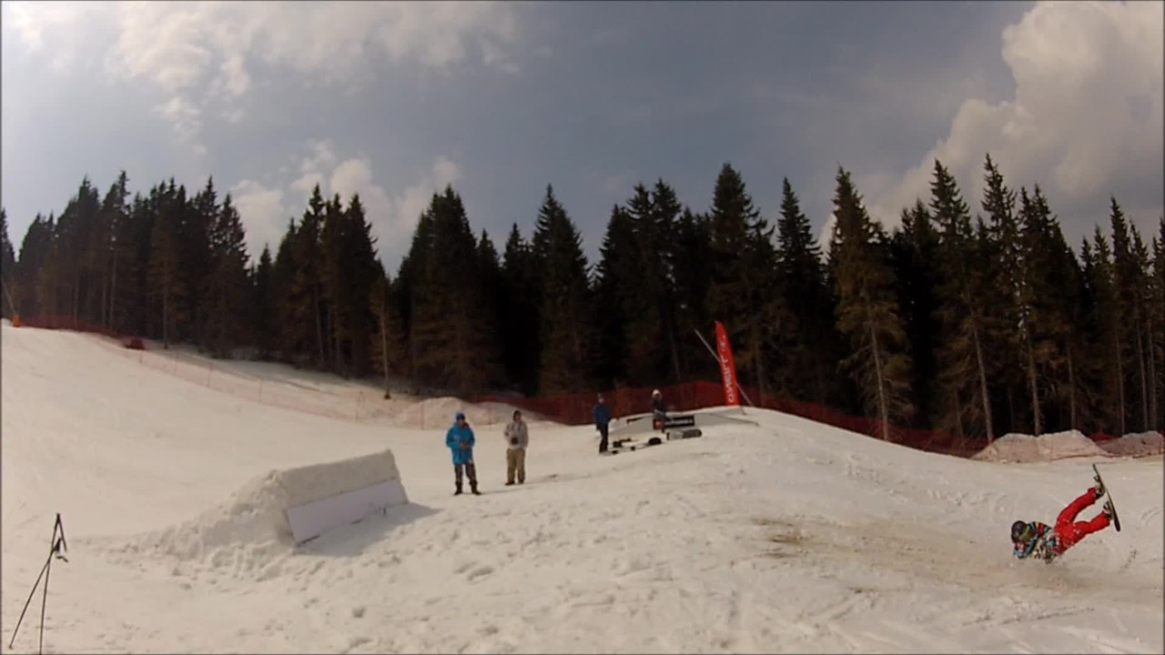Snowboarder wipes out after hitting jump